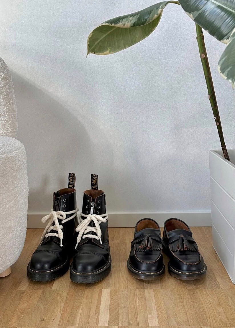 Dr.Martens boots and penny loafers lined up on the floor