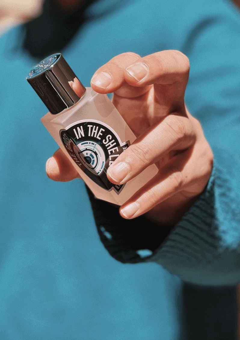 Hand holding a cologne bottle
