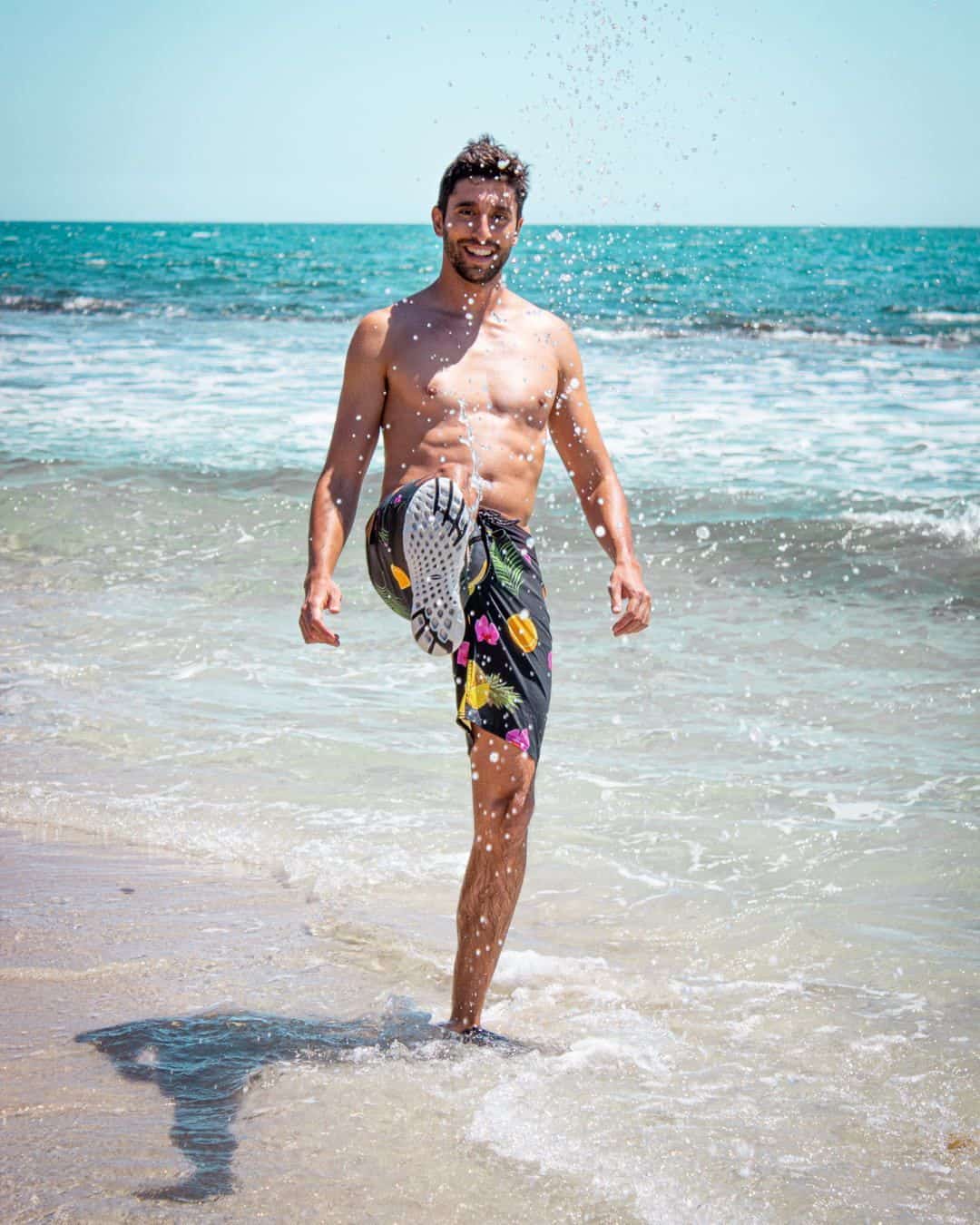 Man wearing water shoes at the beach
