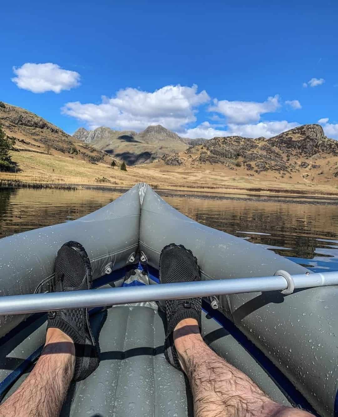 Man on a water raft wearing water shoes