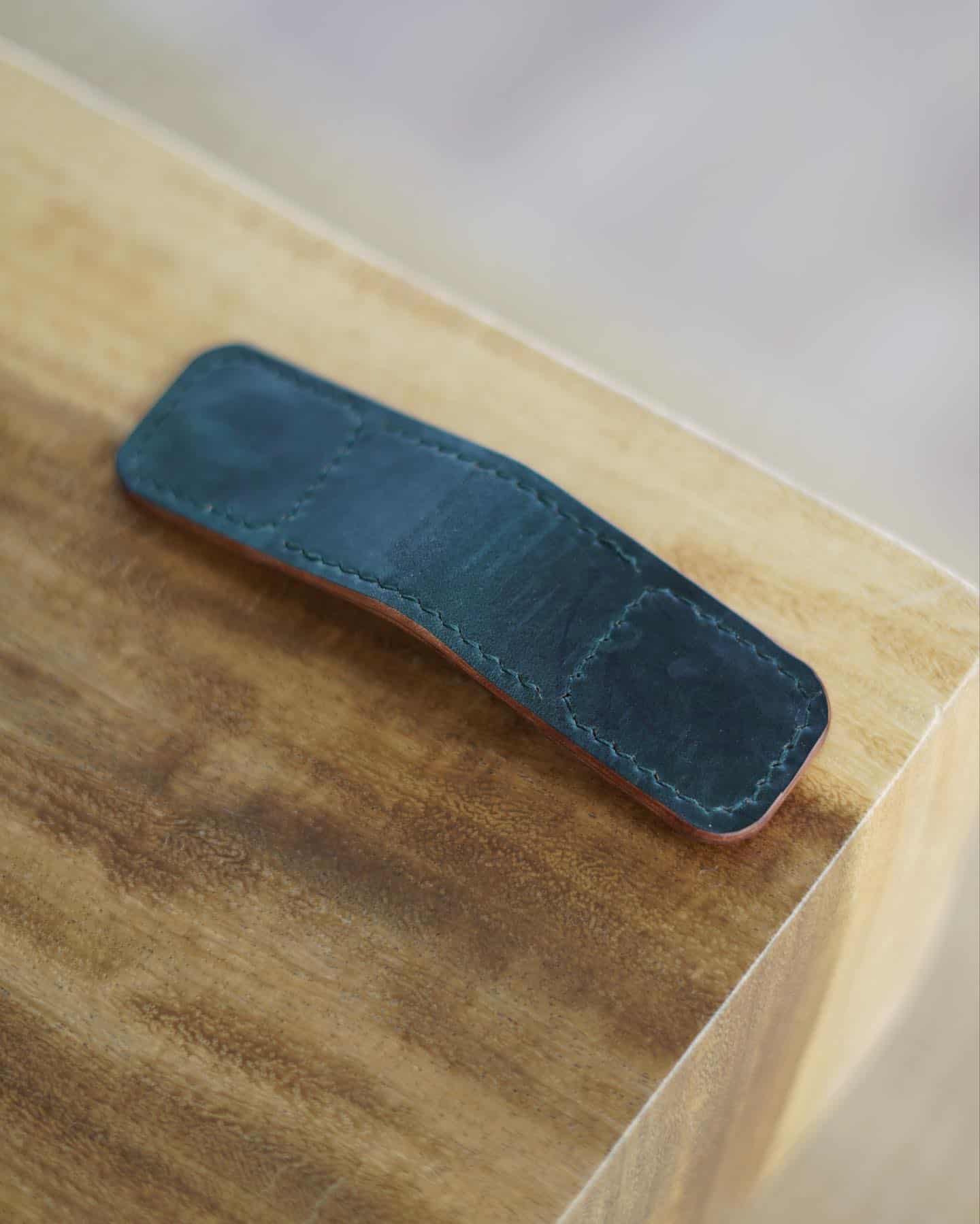 Small mpney clip on top of a wooden table