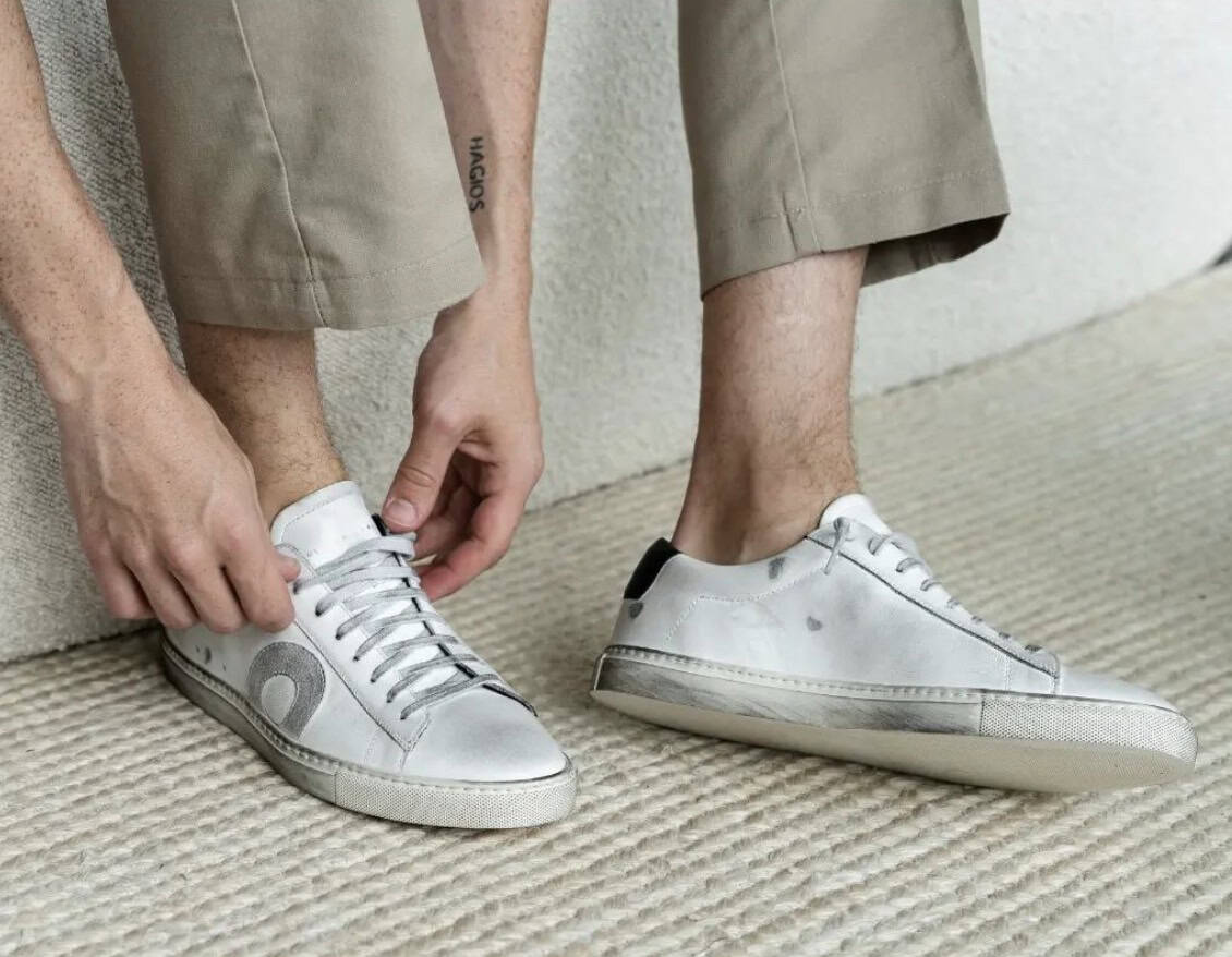 man putting on sneakers with the best no show socks
