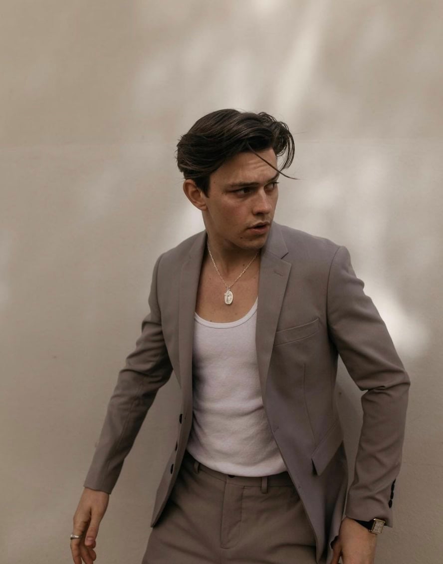 man wearing undershirt and blazer