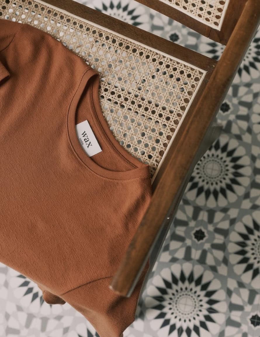 shirt laying on a wicker chair