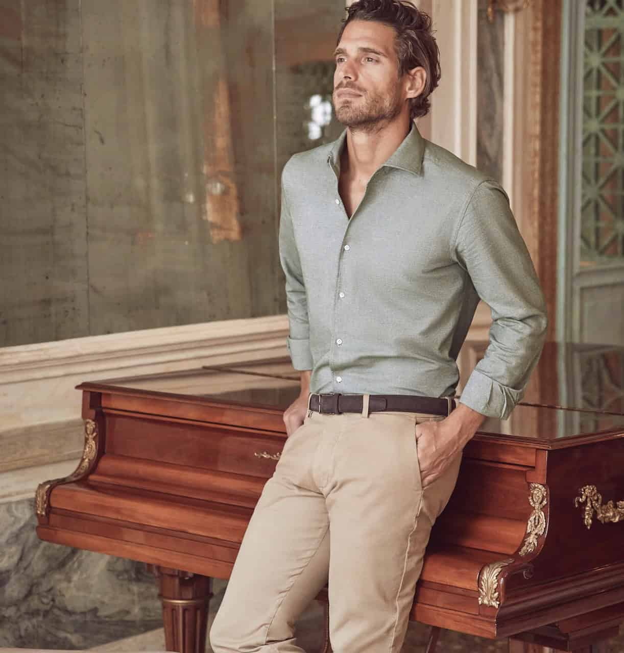 man leaning against a piano