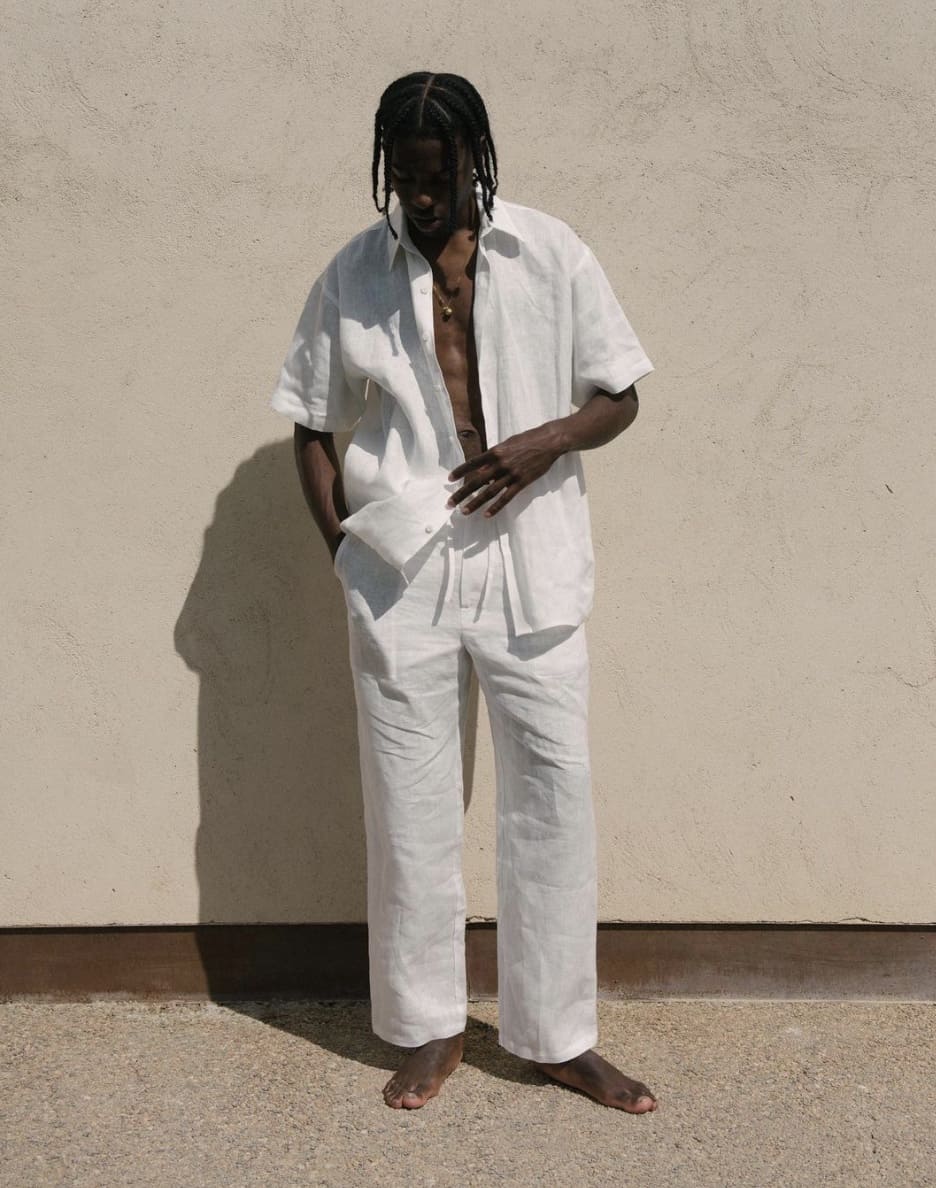 man standing in a white linen outfit