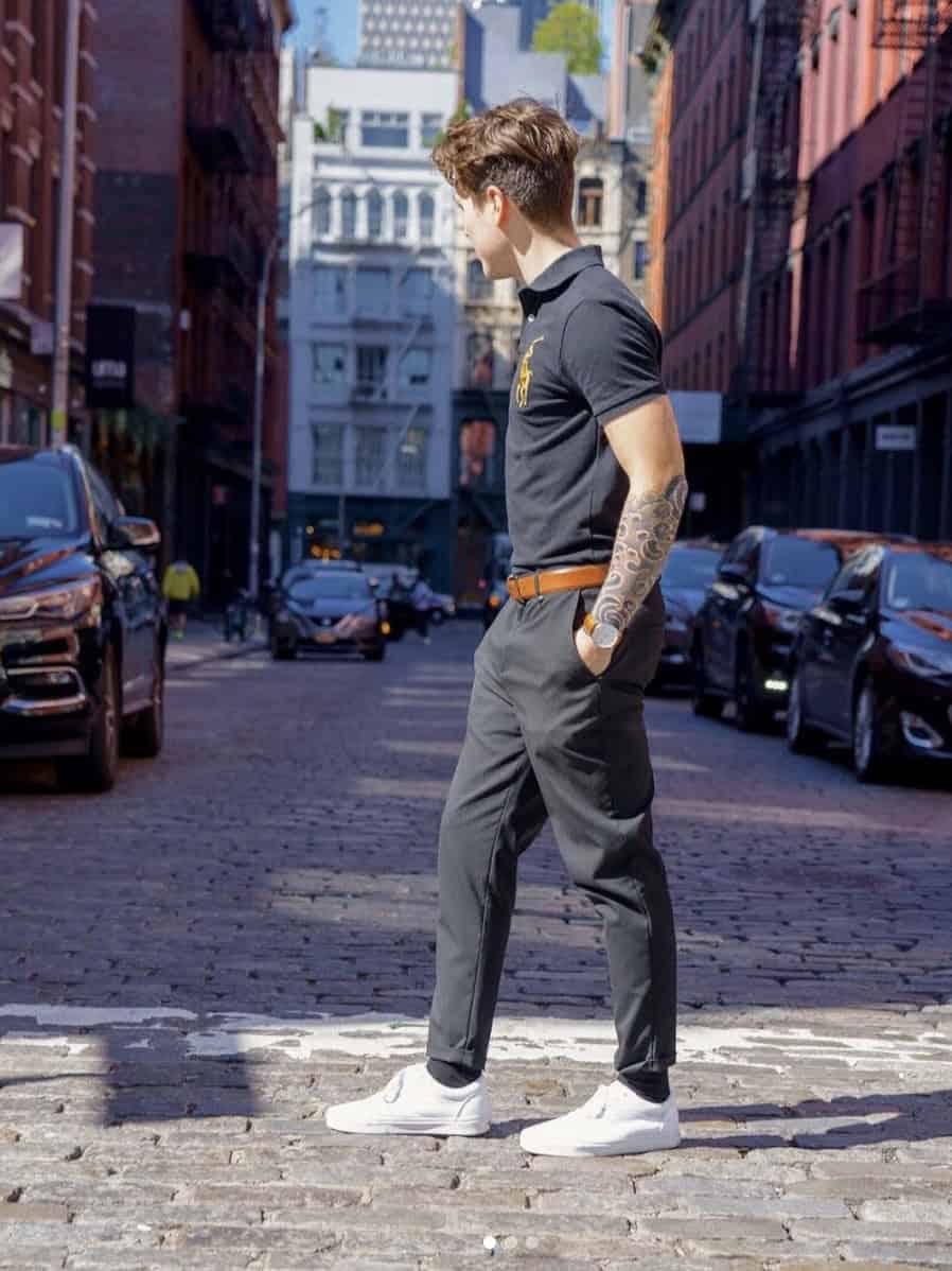 man wearing white vans crossing the street