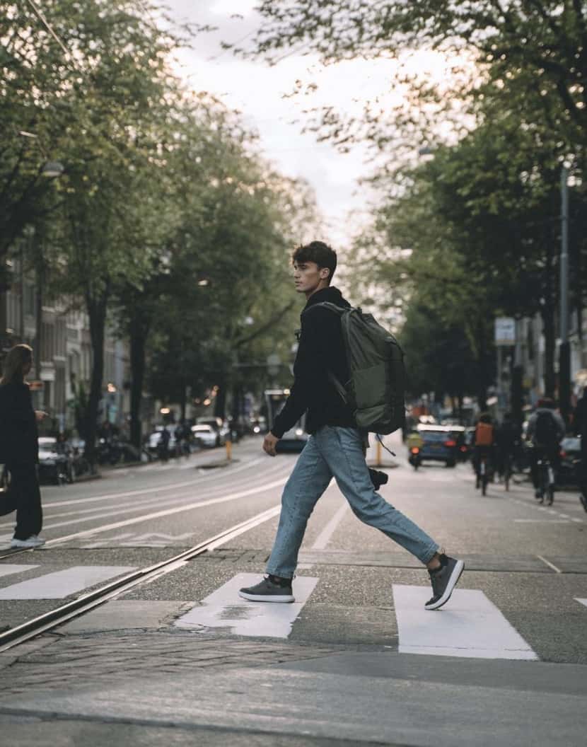 man walking across the street wearing tropicfeel 