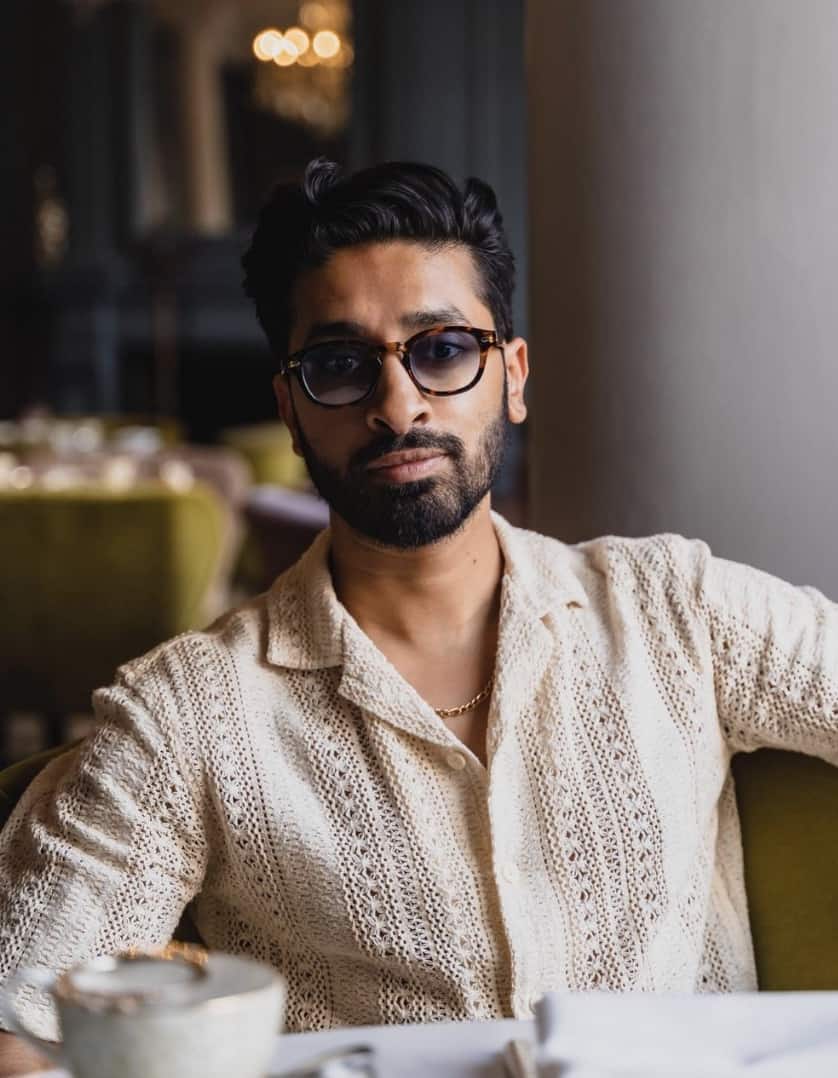 man sitting at a table staring directly into the camera
