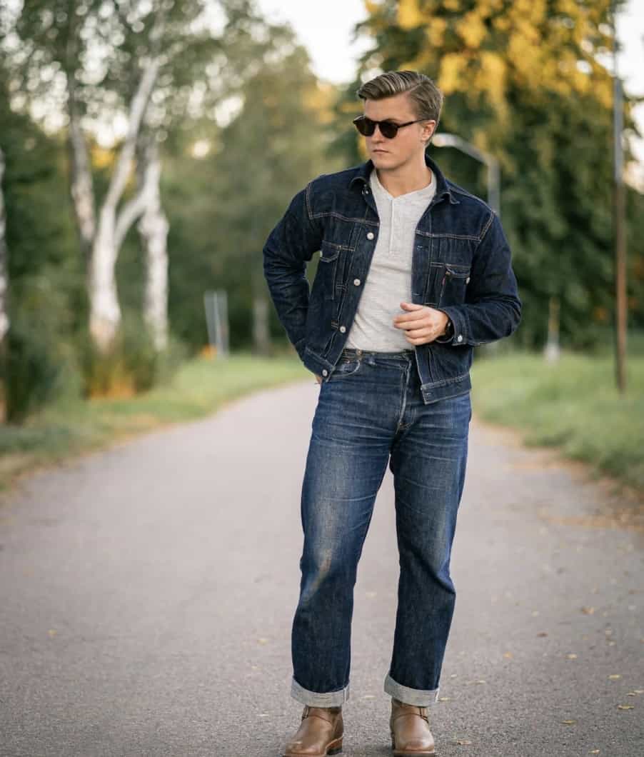man walking on a road in double denim