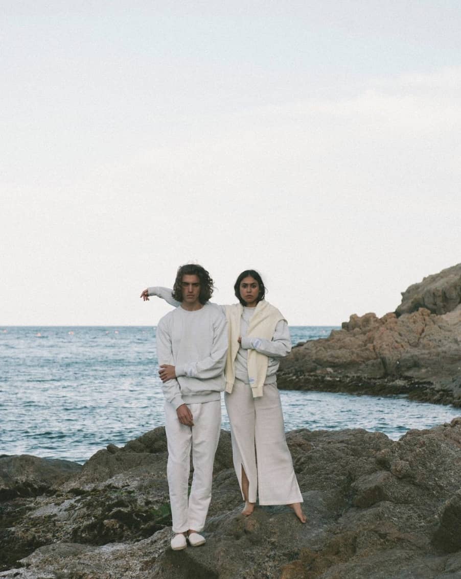 Couple standing on rocks by the ocean