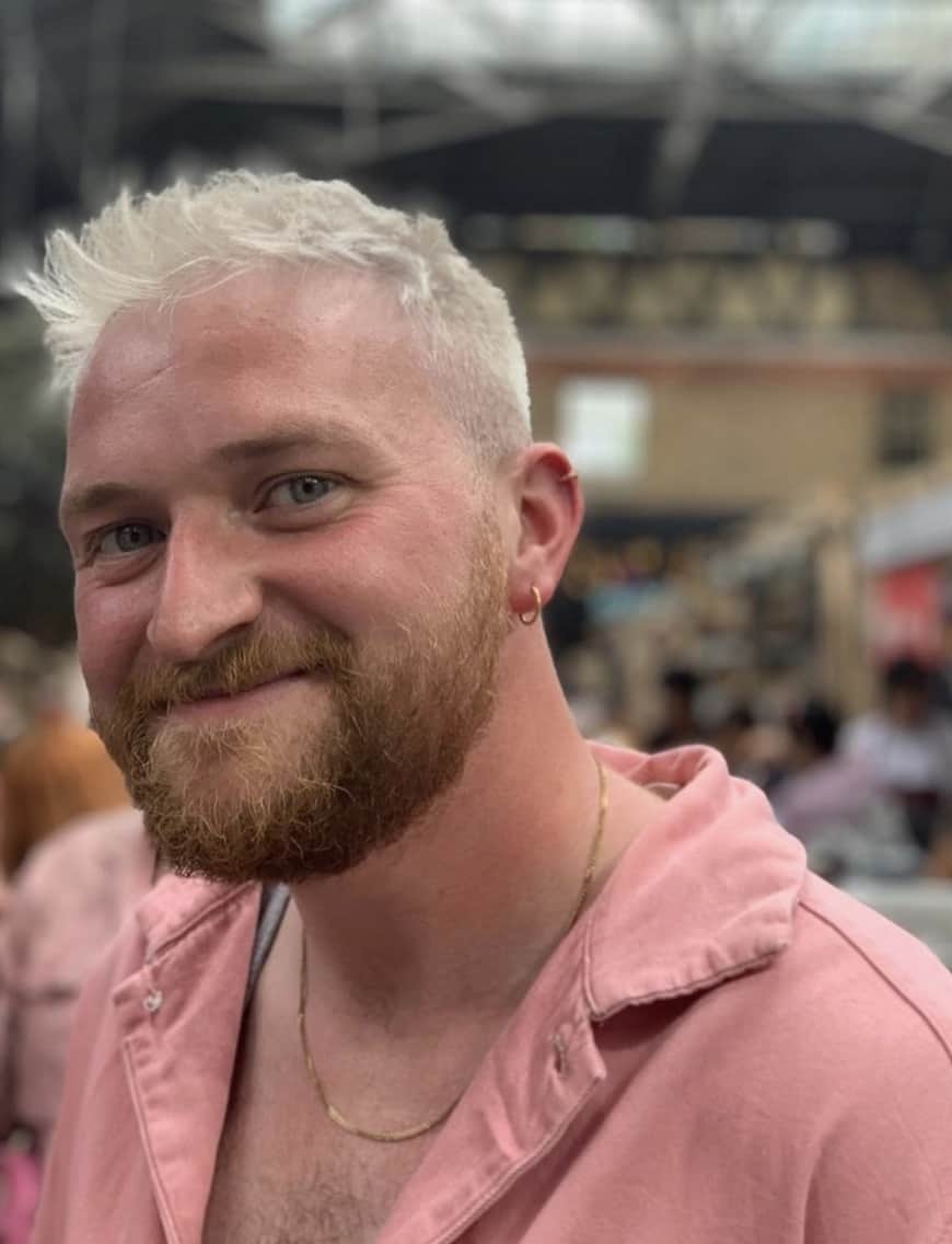 man looking at the camera showing off ear piercings