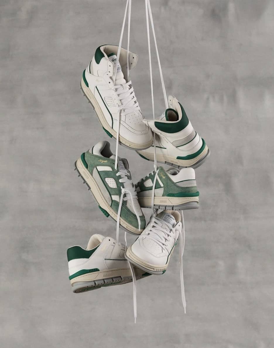 Shoes hanging together against a grey background