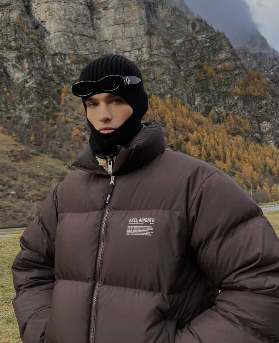 man outside in a puffer jacket and balaclava 