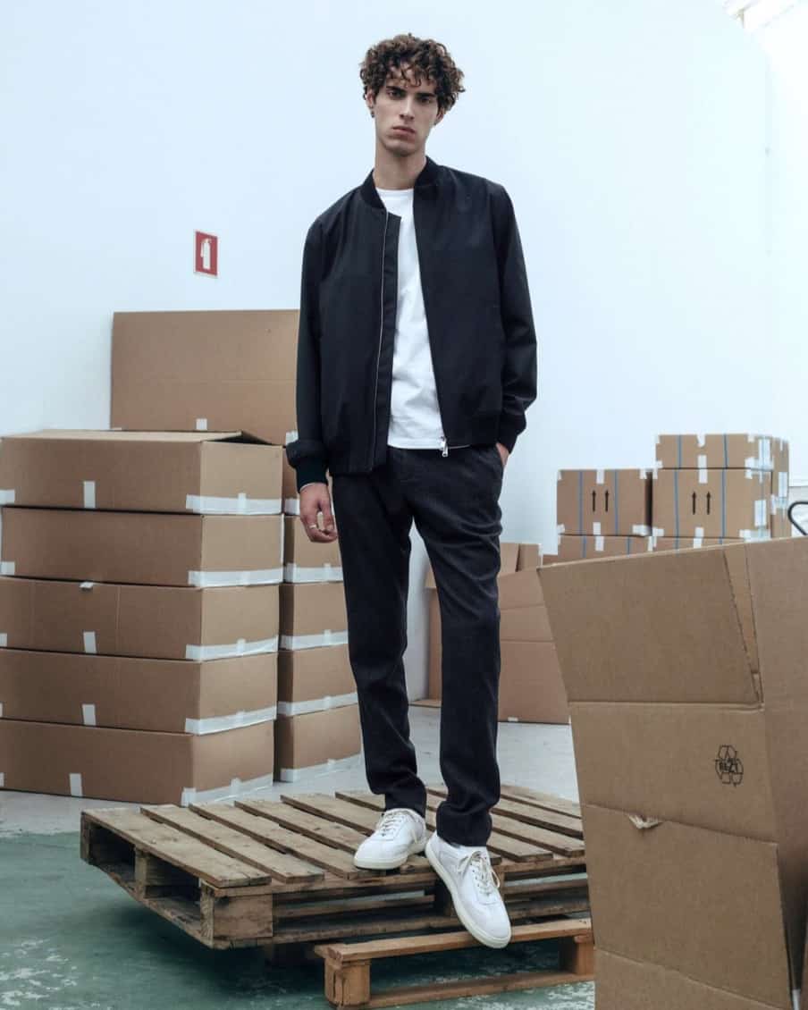 Man standing on a pallet modelling L’Estrange clothing