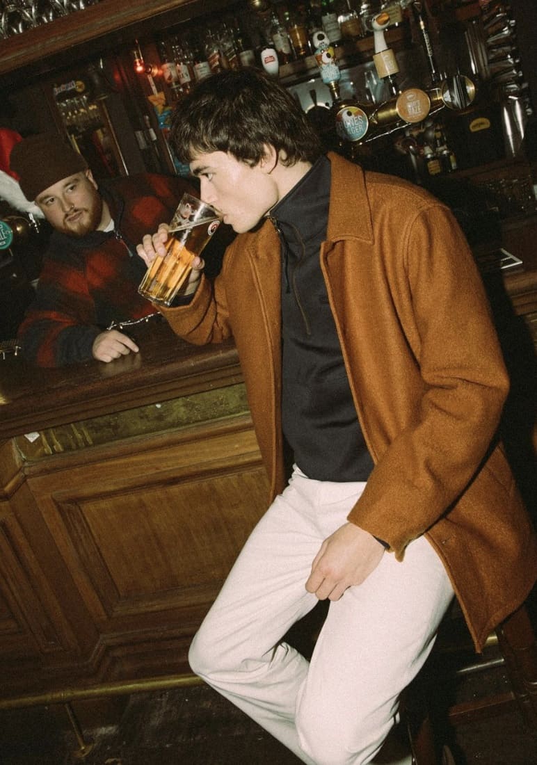 man drinking a beer at the bar