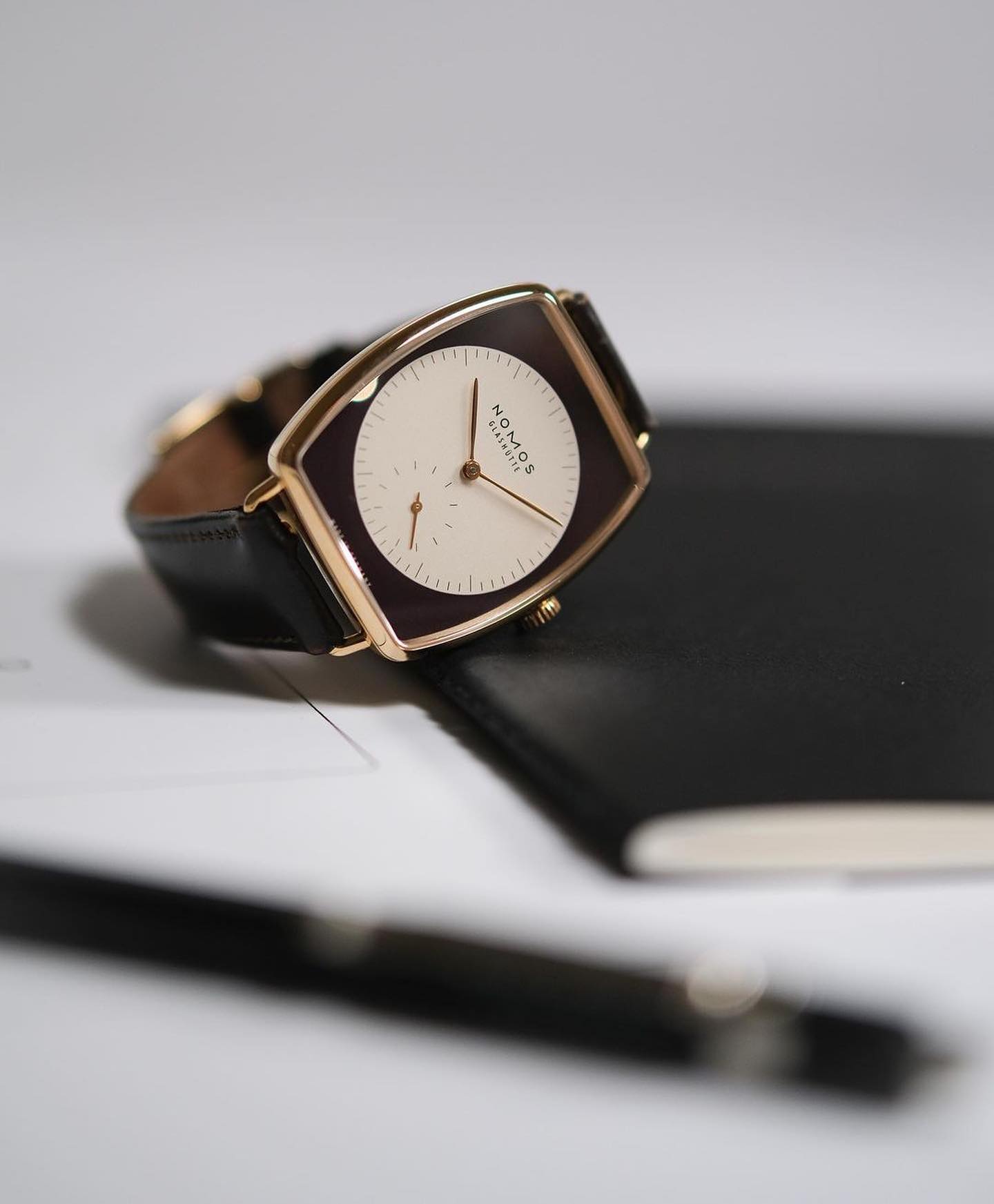 Nomos Glashütte Lux on top of a notebook