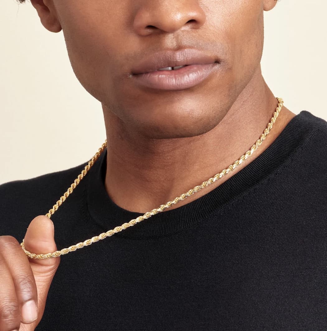 man tugging on a gold rope chain