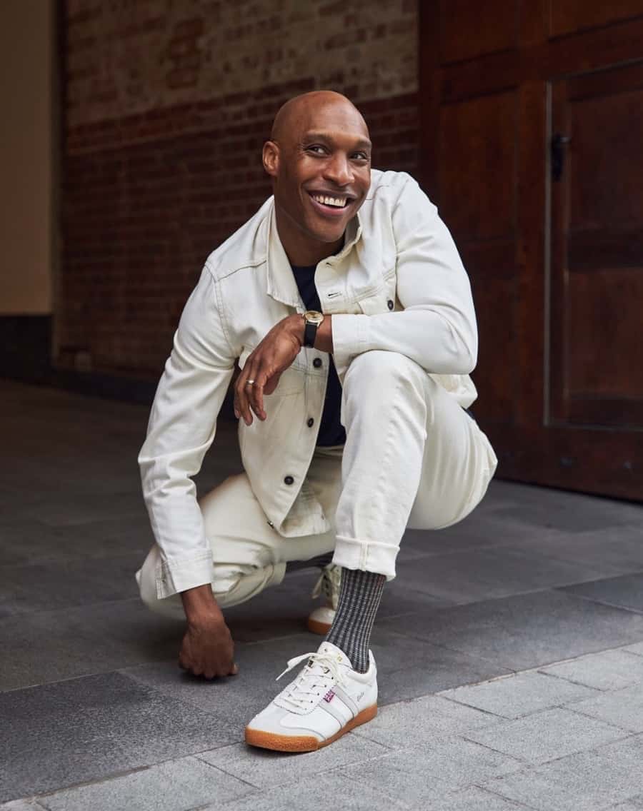 man wearing white outfit showing off socks from London Sock Co