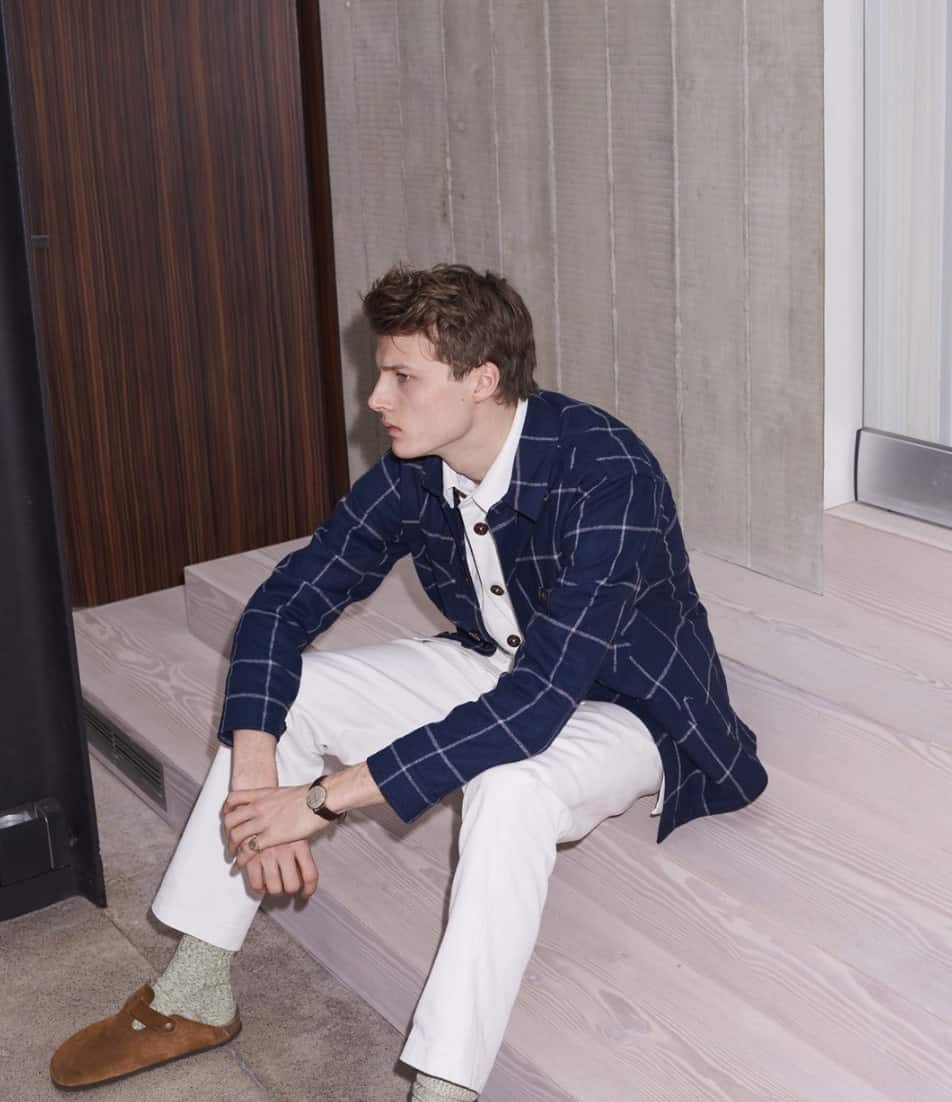 man sitting on a couch looking away from the camera