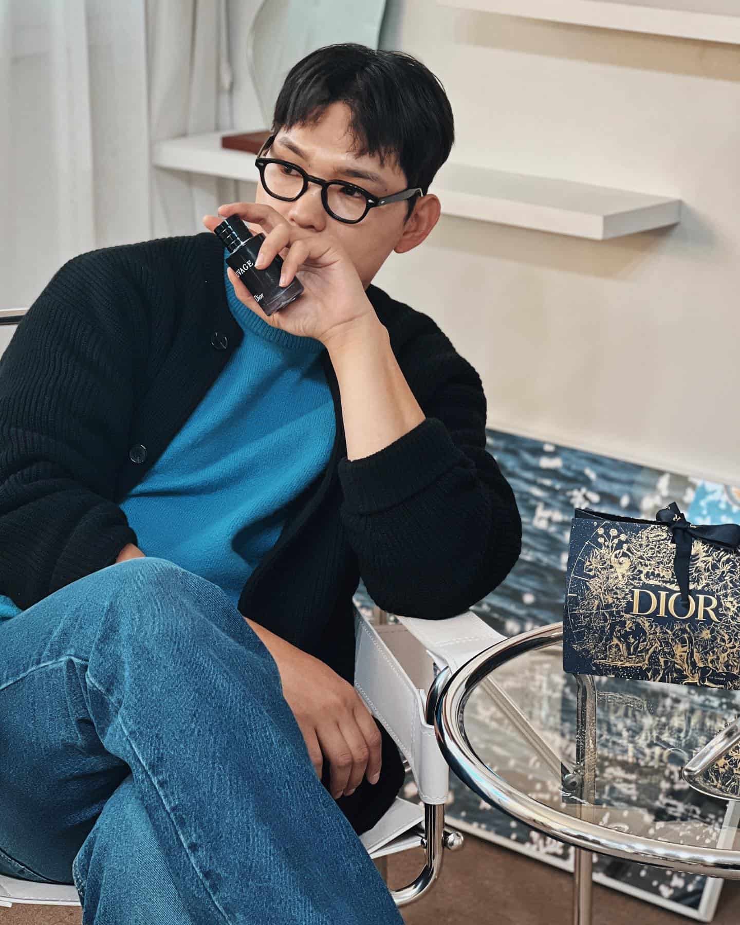 Man Holding a bottle of Dior Sauvage