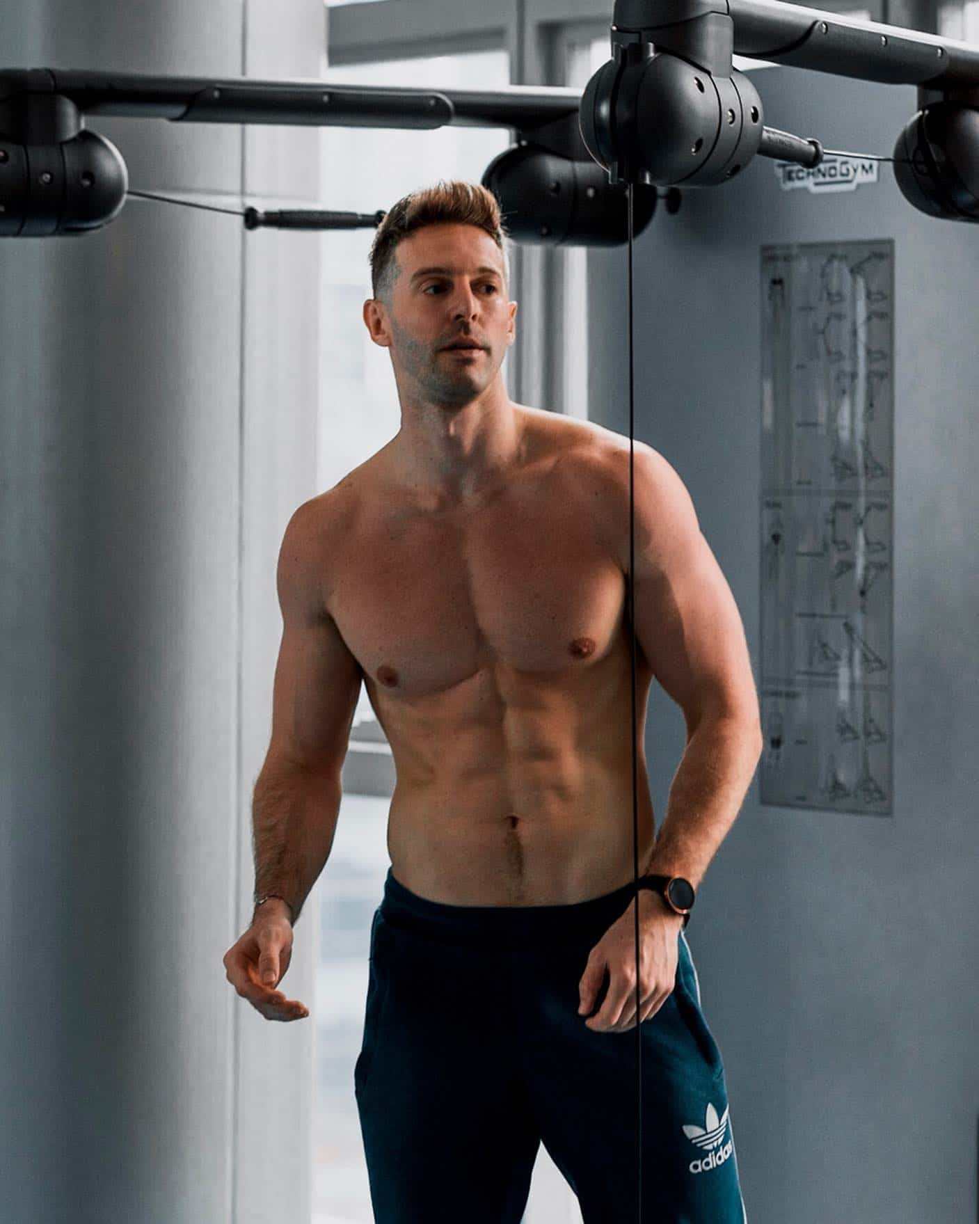 a topless man hitting the gym