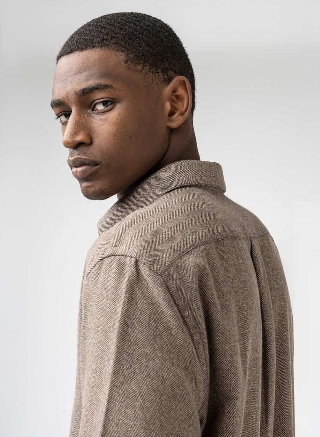 man wearing brown flannel shirt