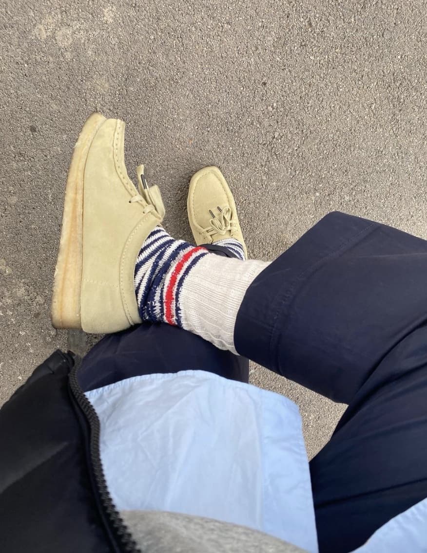 man showing off Clark Wallabees and ThundersLove Sock