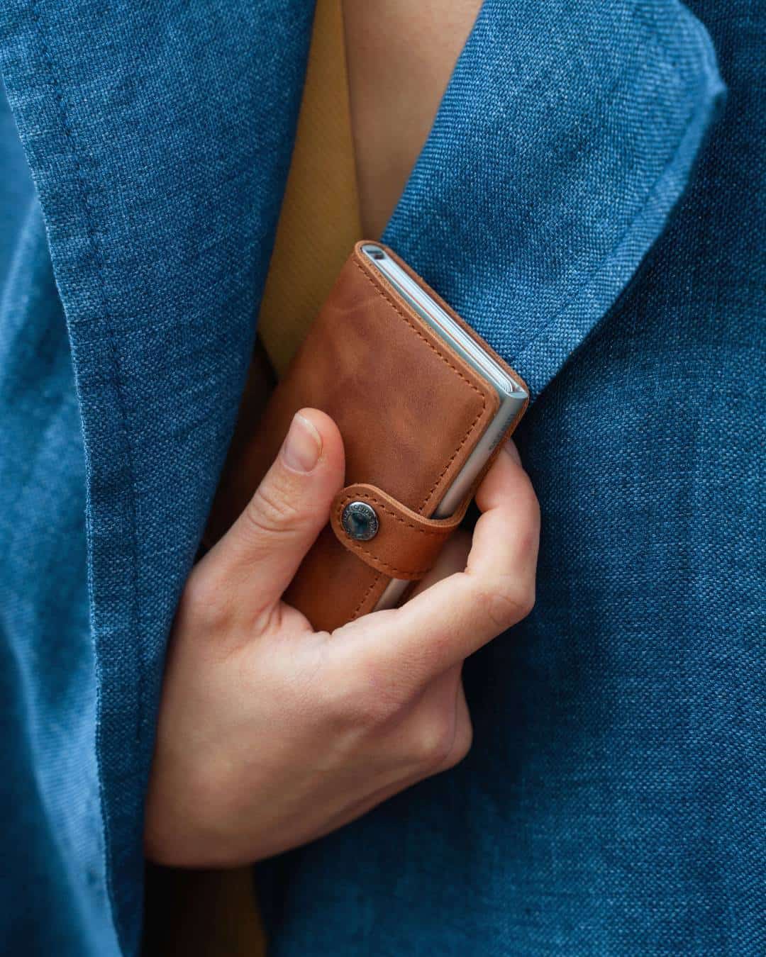 Pulling Out A Secrid Mini Wallet From Jacket