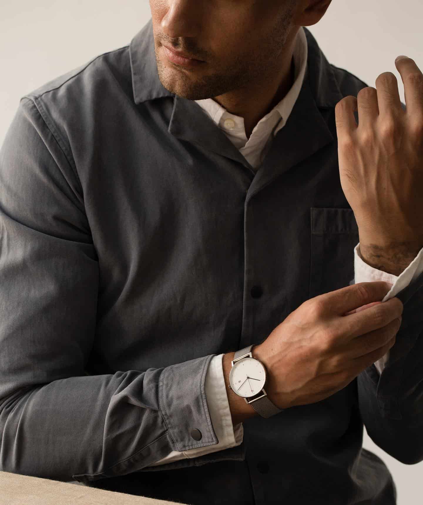 a man fixing his cuffs