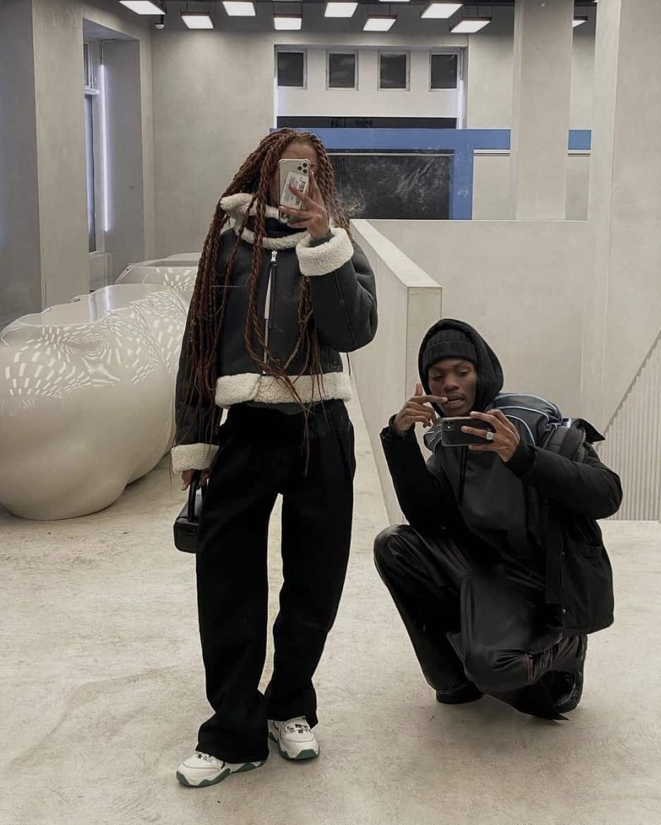 man and women taking a photo in a mirror