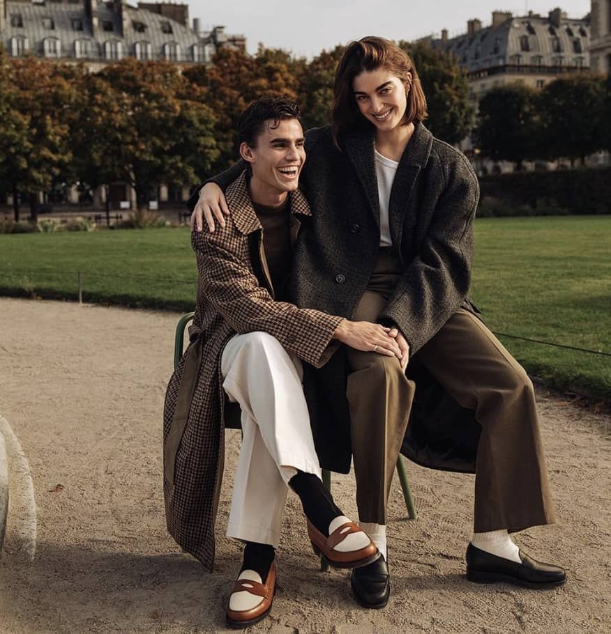 women sitting on a man's lap outside