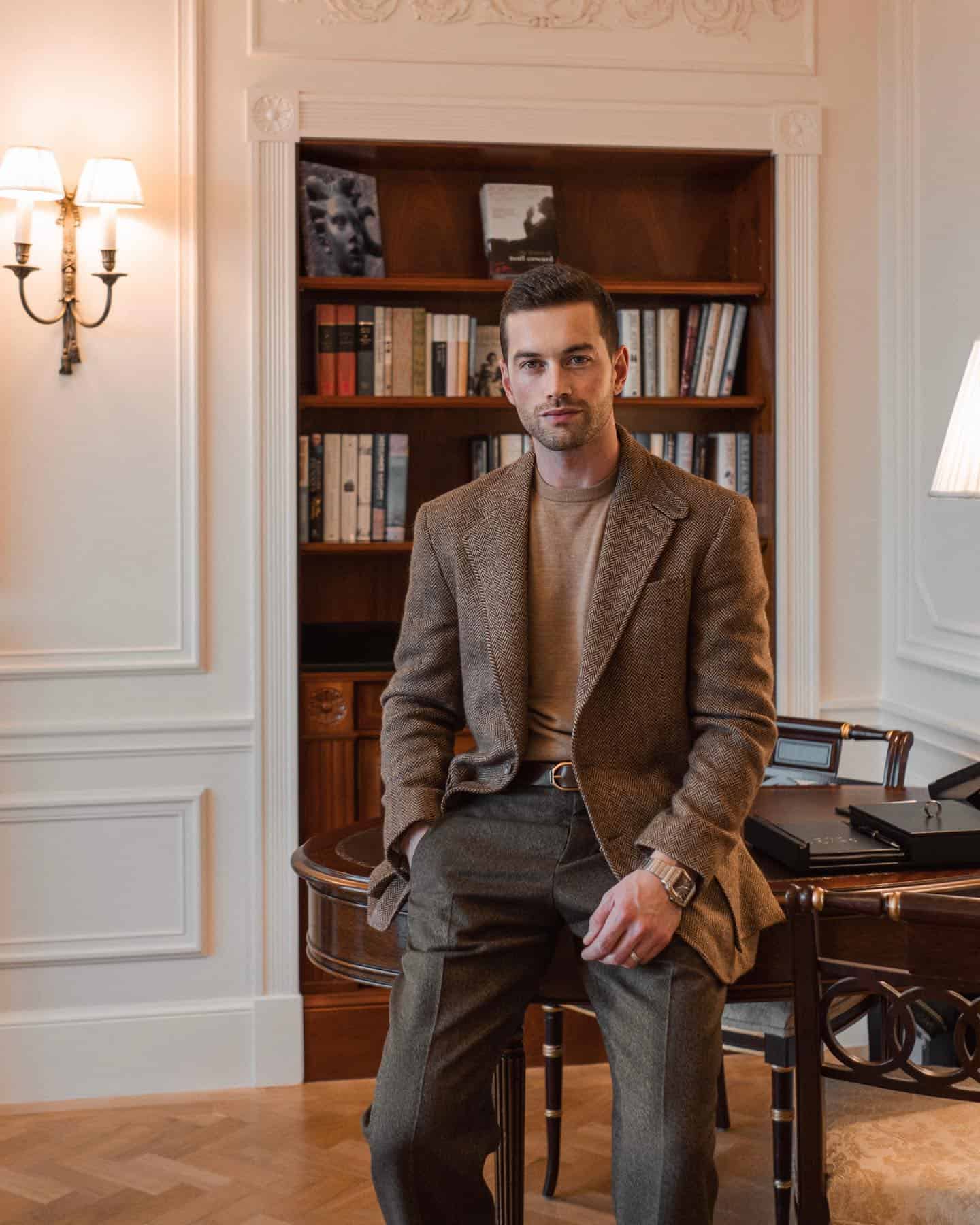 a man in a suit jacket is sitting on the table