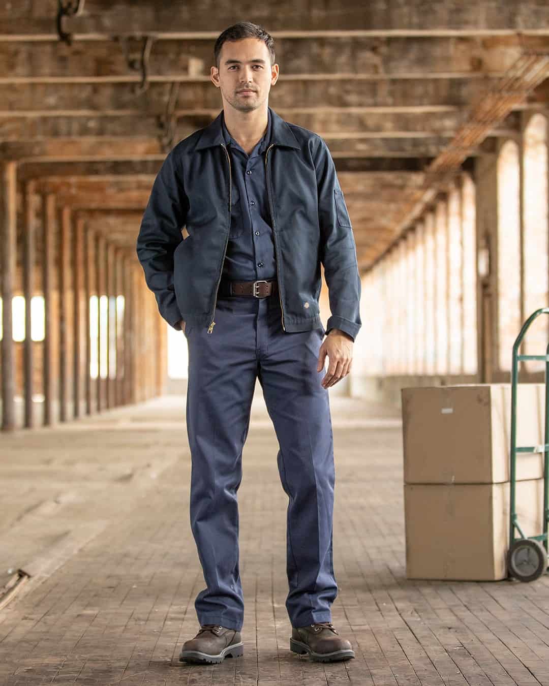 man wearing a jacket over a uniform