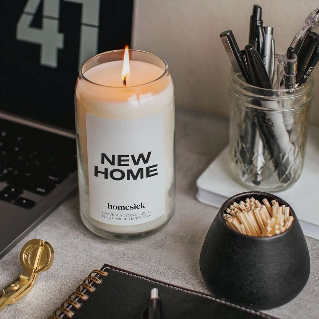 a lit scented candle on a work desk