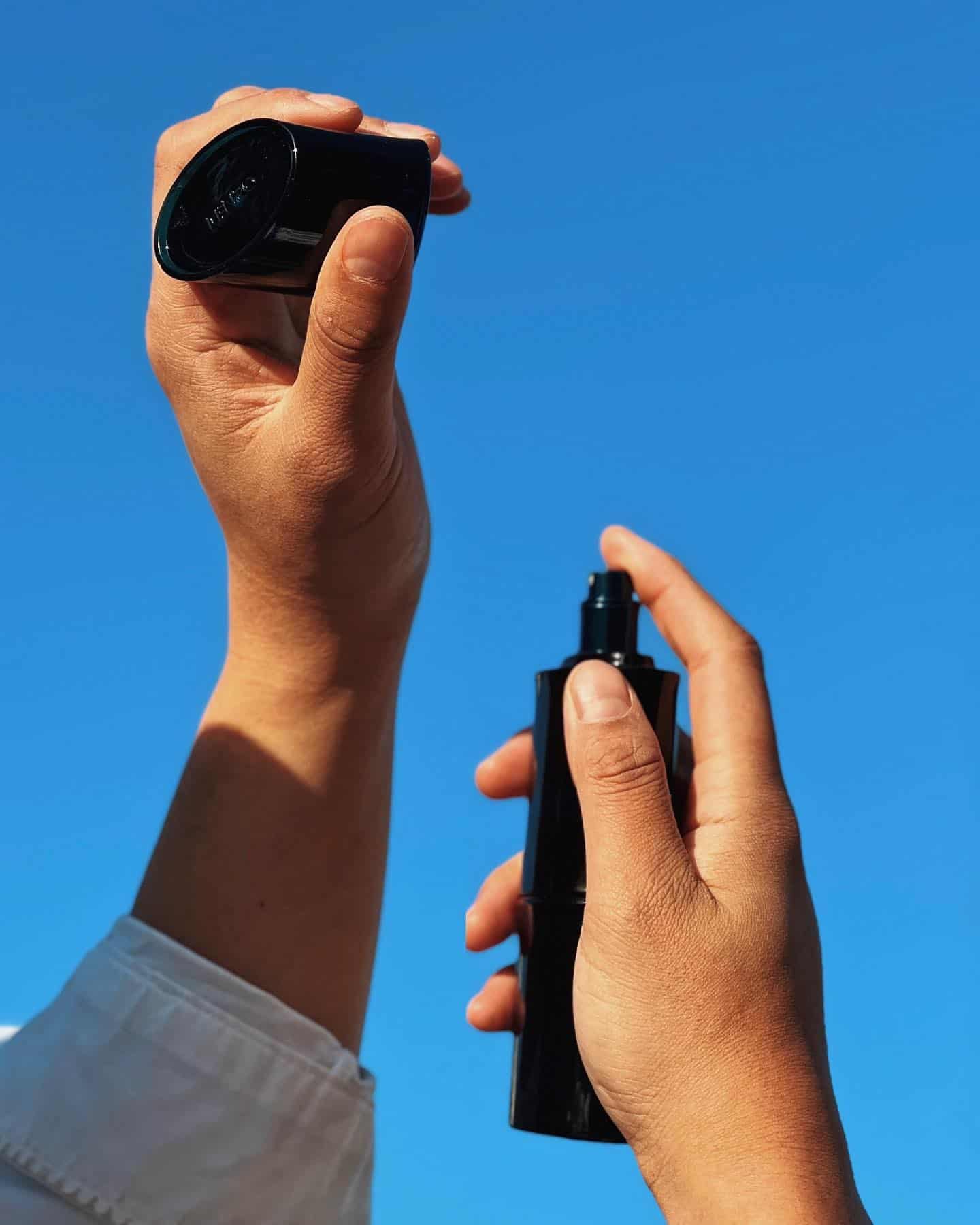 spraying perfume on the wrist