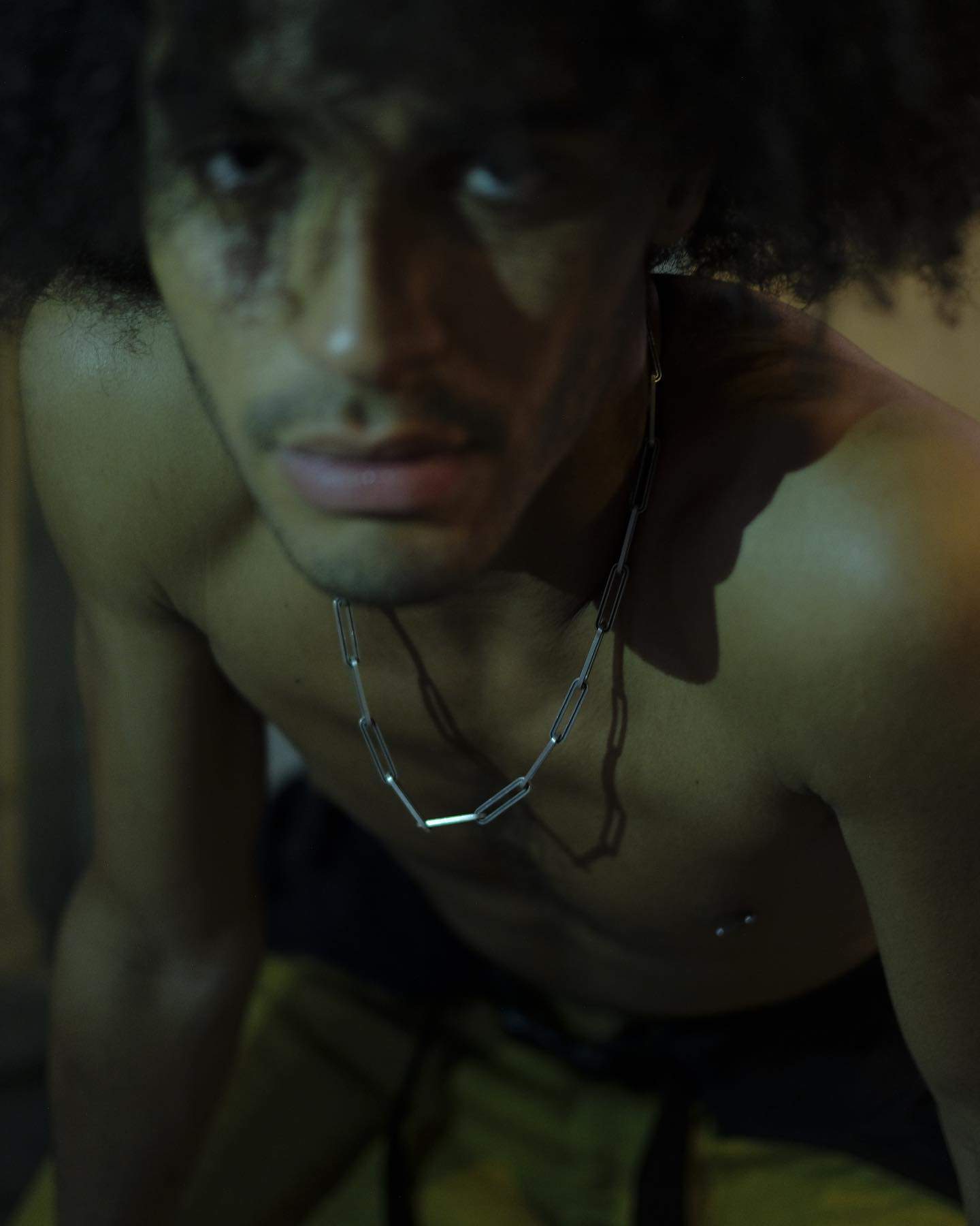 man wearing a silver chain necklace