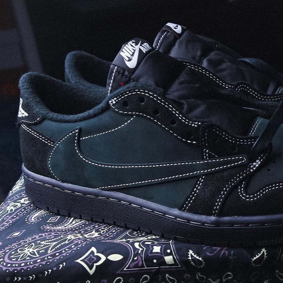 a pair of Travis Scott Jordan 1 Black Phantom