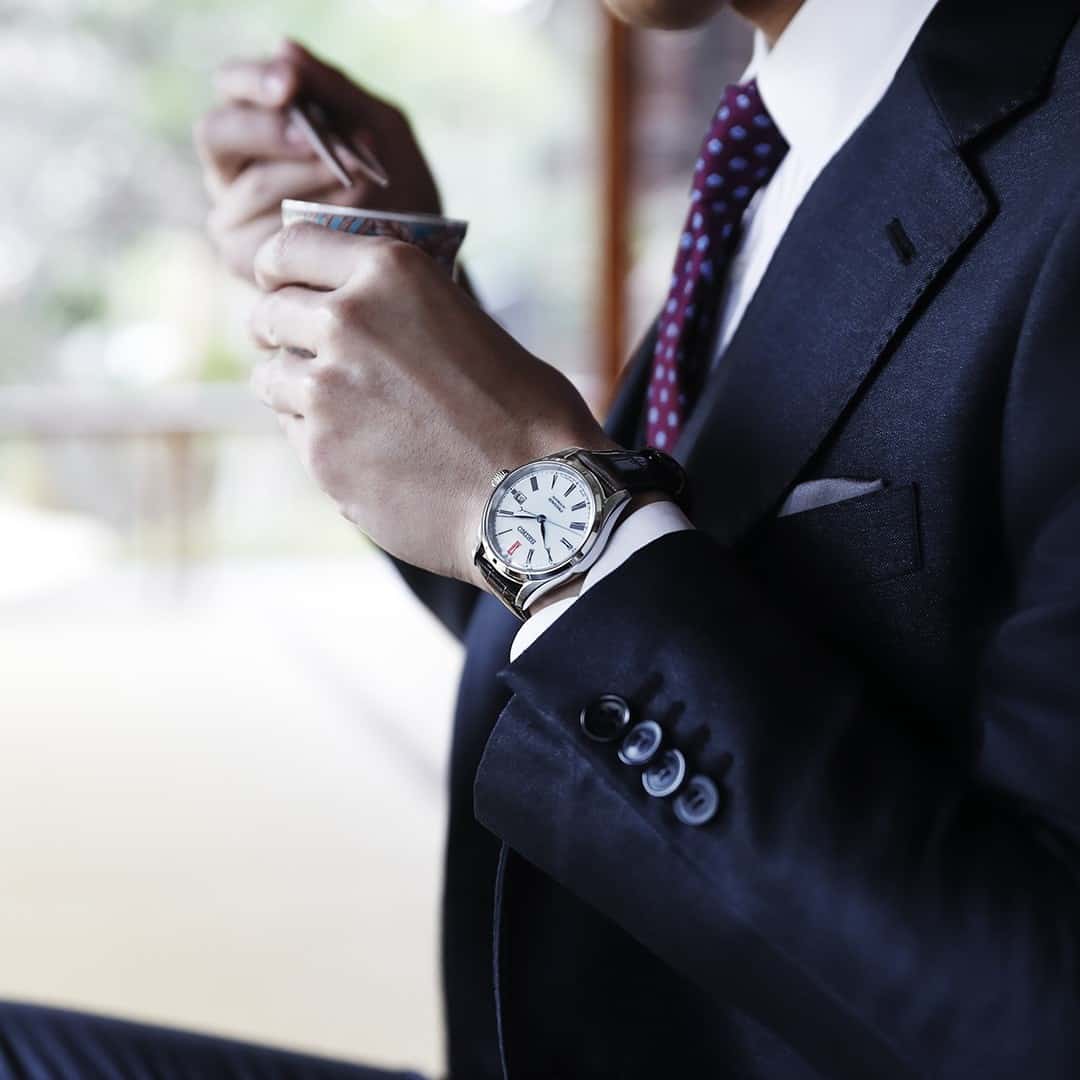 man in a navy suit wearing a presage spb095j1