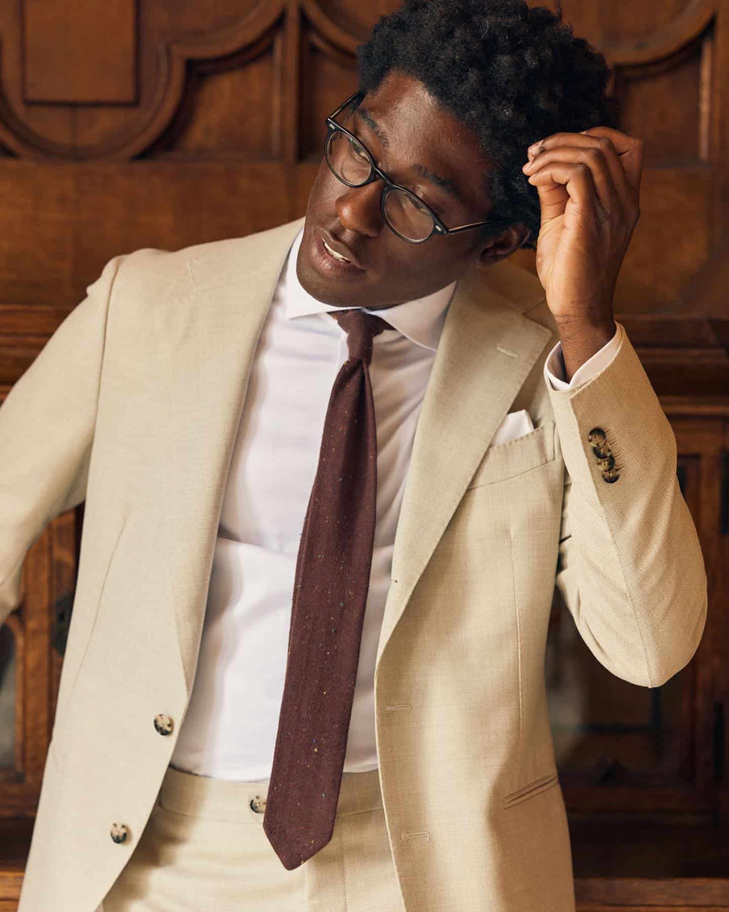 Cream suit and a brown tie