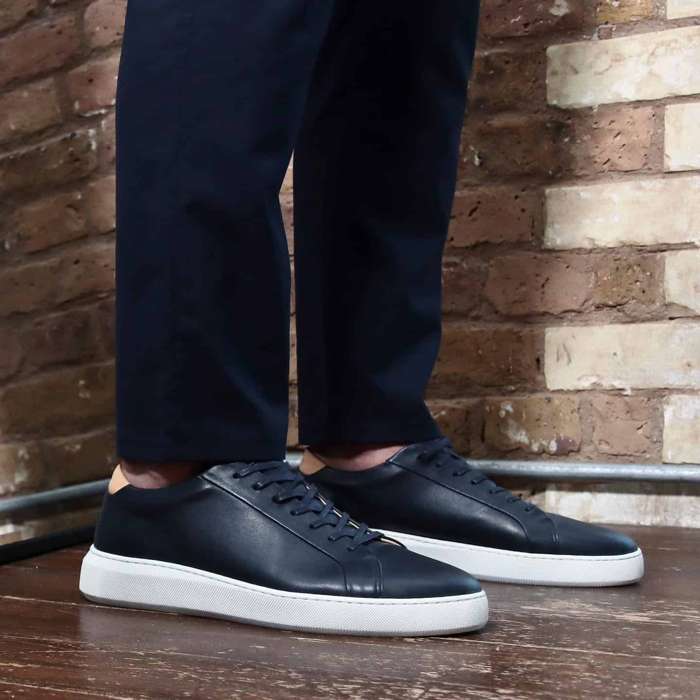 a pair of navy leather sneakers