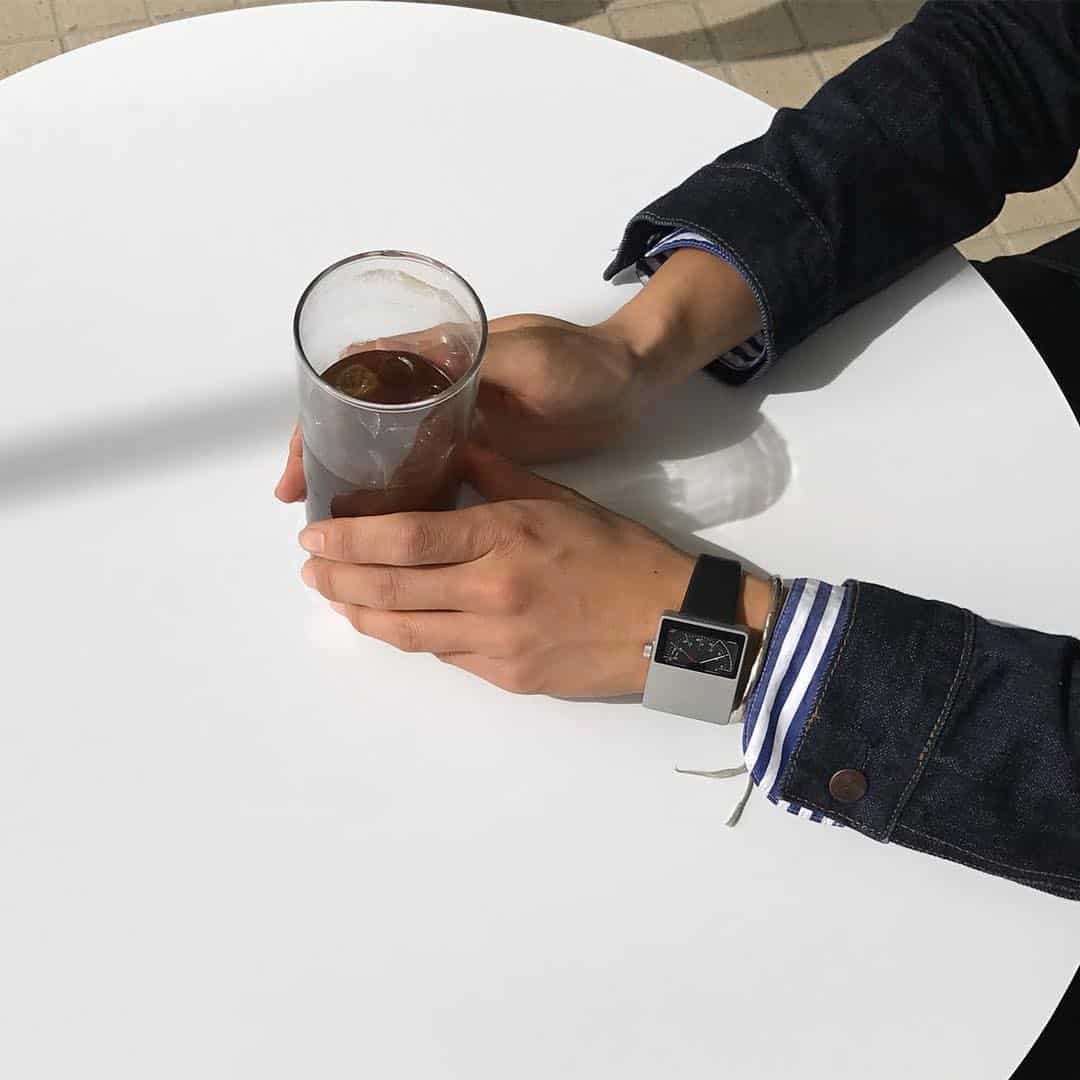 holding a half empty iced tea