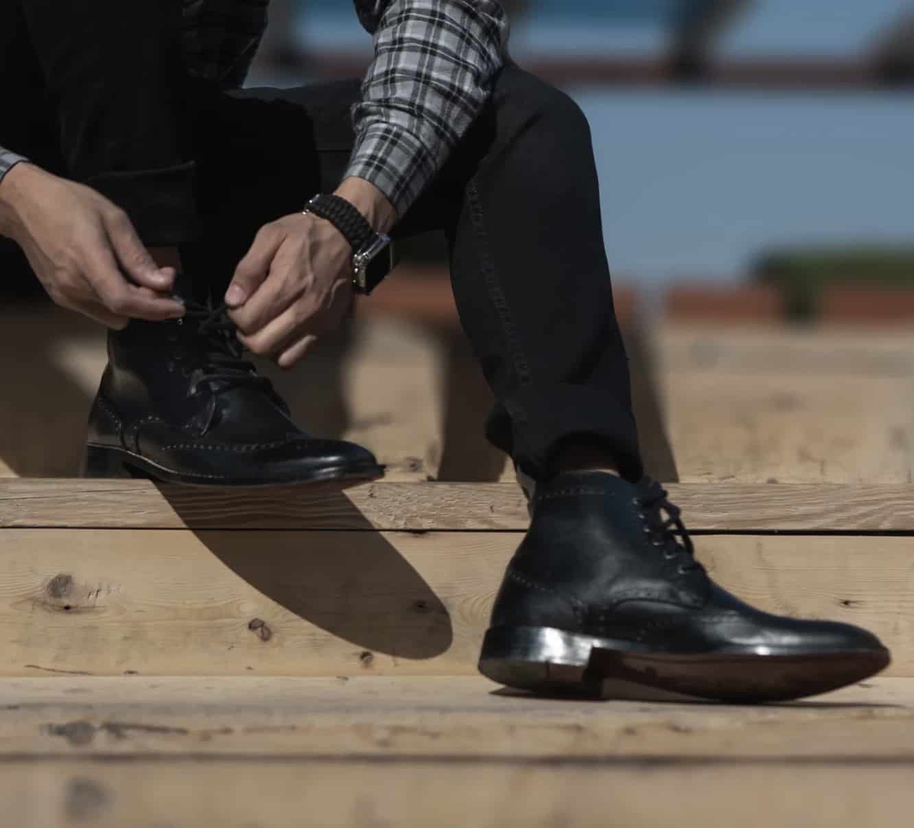 Model tying up boots from the jacket maker 