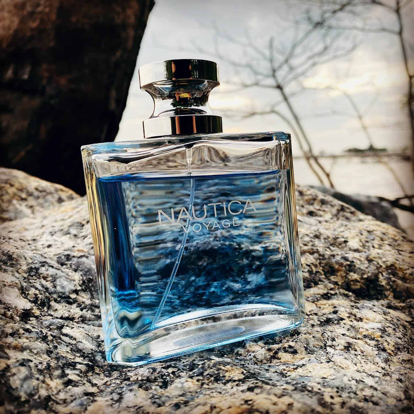 a bottle of nautica voyage on a rock