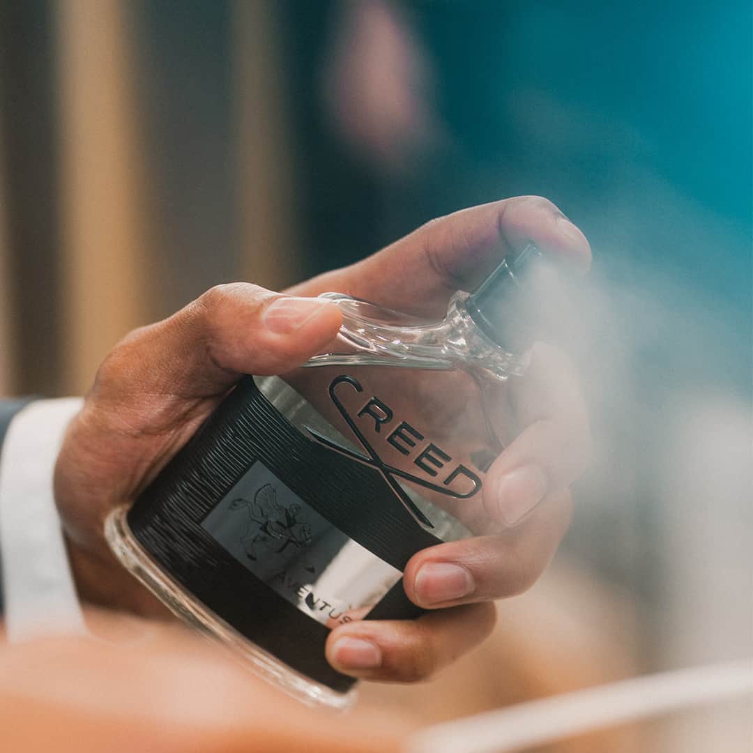 pressing the spray of a creed aventus cologne