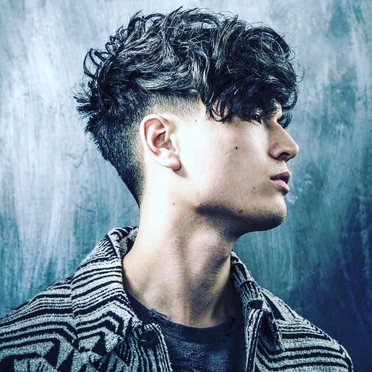 a man with a curly hair style