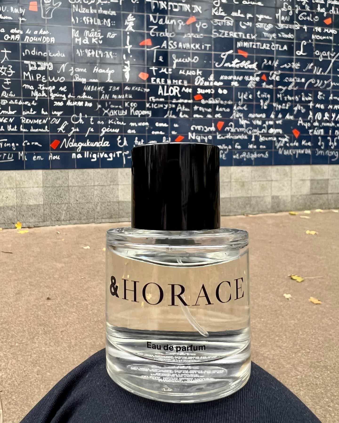 placing on top of a knee a bottle of Horace Eau De Parfum