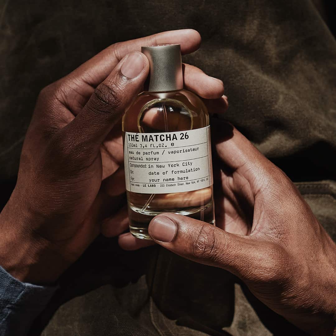 holding a bottle of the matcha 26 by le labo