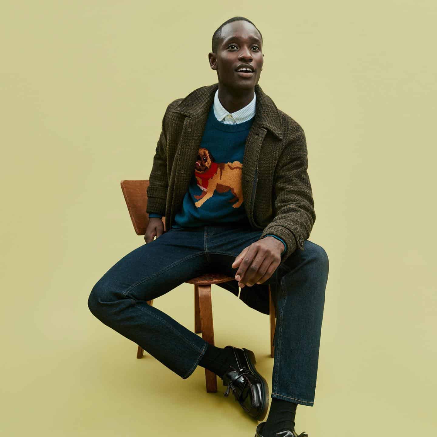 man in an overshirt sitting on a chair
