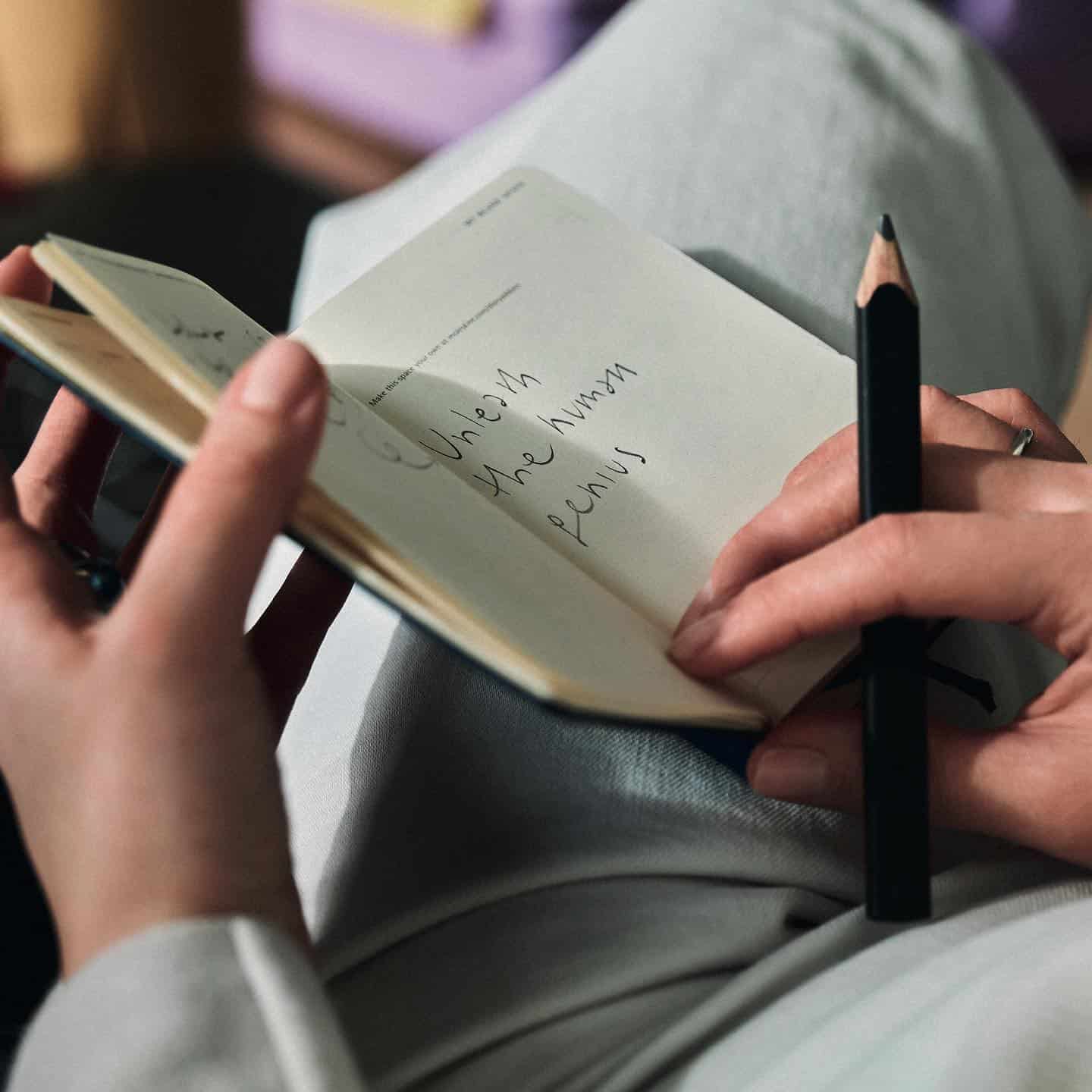 taking notes with a small notebook